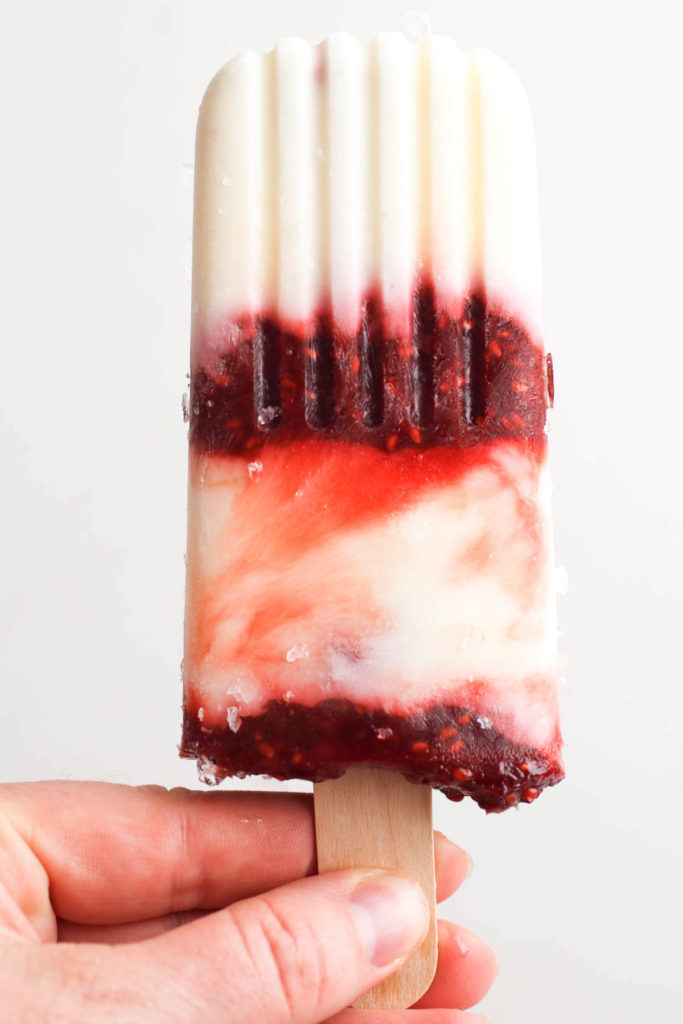 Homemade creamy yogurt popsicles with raspberry rhubarb swirl. A healthy snack or a quick breakfast and only 84 calories!