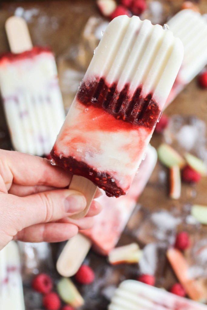 Homemade creamy yogurt popsicles with raspberry rhubarb swirl. A healthy snack, quick breakfast and only 84 calories!