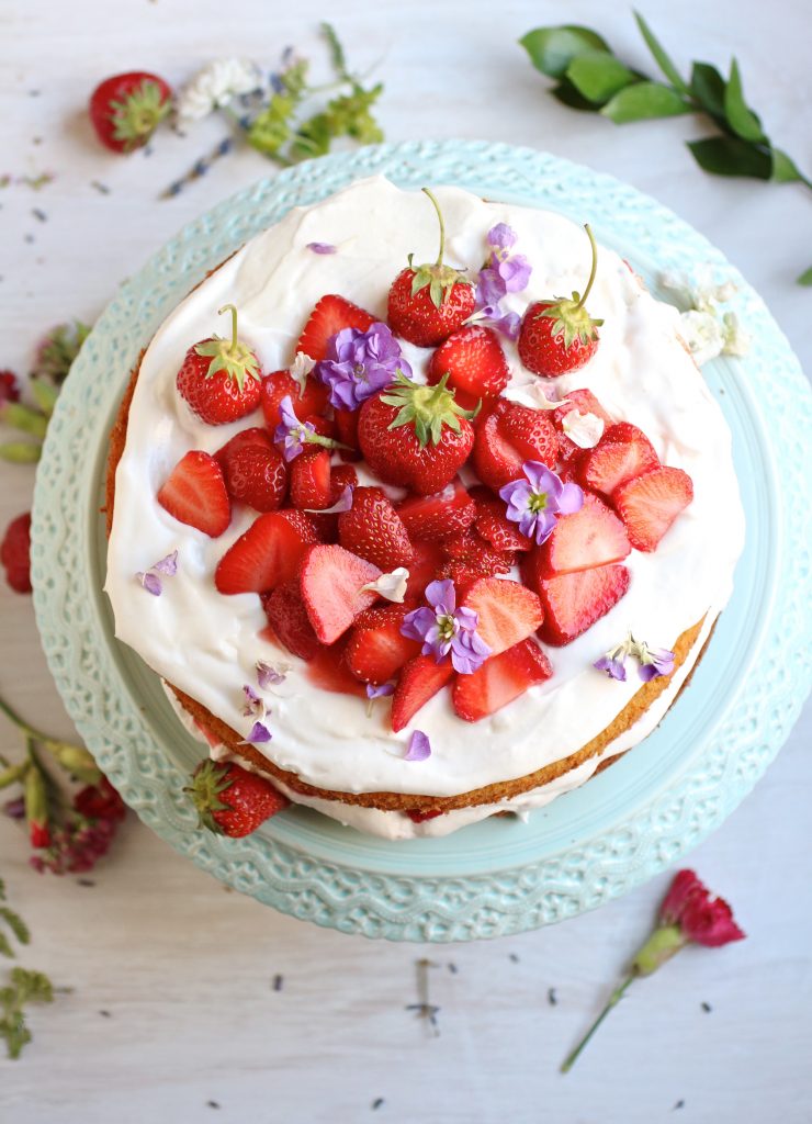 Gluten free strawberry almond cake is a light fluffy cake piled high with vegan whipped coconut cream and sweet fresh strawberries. Yum!