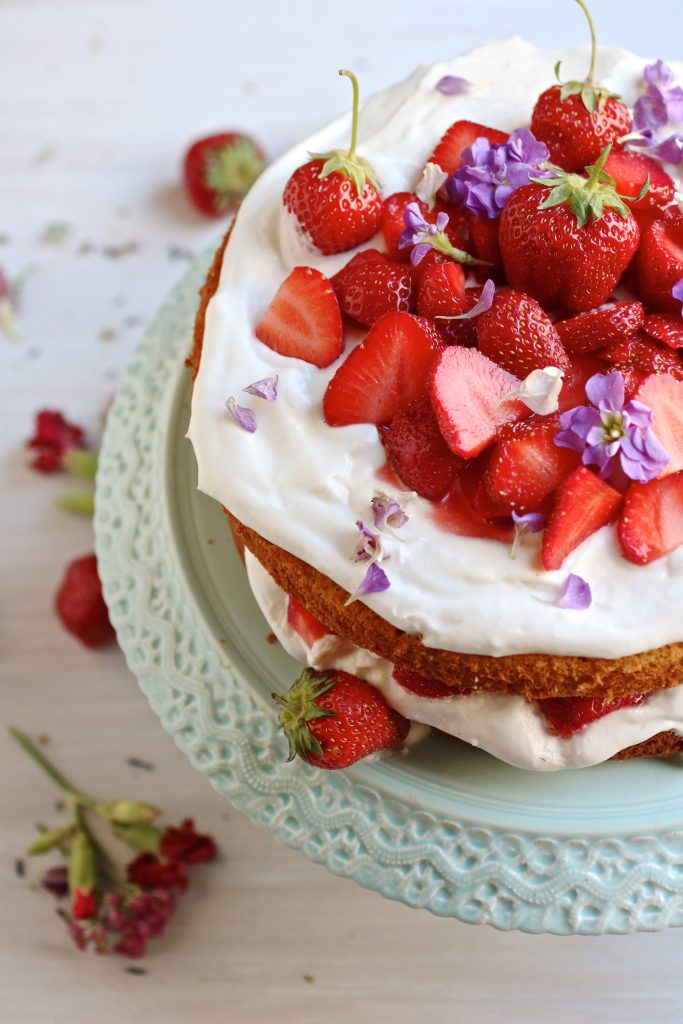 Gluten free strawberry almond cake is a light fluffy cake piled high with vegan whipped coconut cream and sweet fresh strawberries. Yum!
