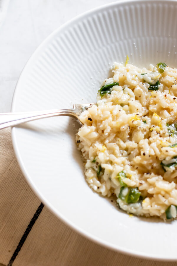 Instant Pot Risotto with Wild Ramps and Parmesan in a white bowl with a fork