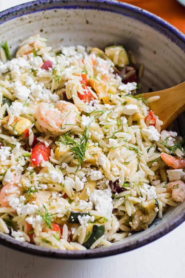 Loaded with fresh roasted vegetables, shrimp, dill, and feta cheese this Mediterranean inspired lemony orzo salad is a quick and easy summer side dish and is fantastic served warm or cold.Â 