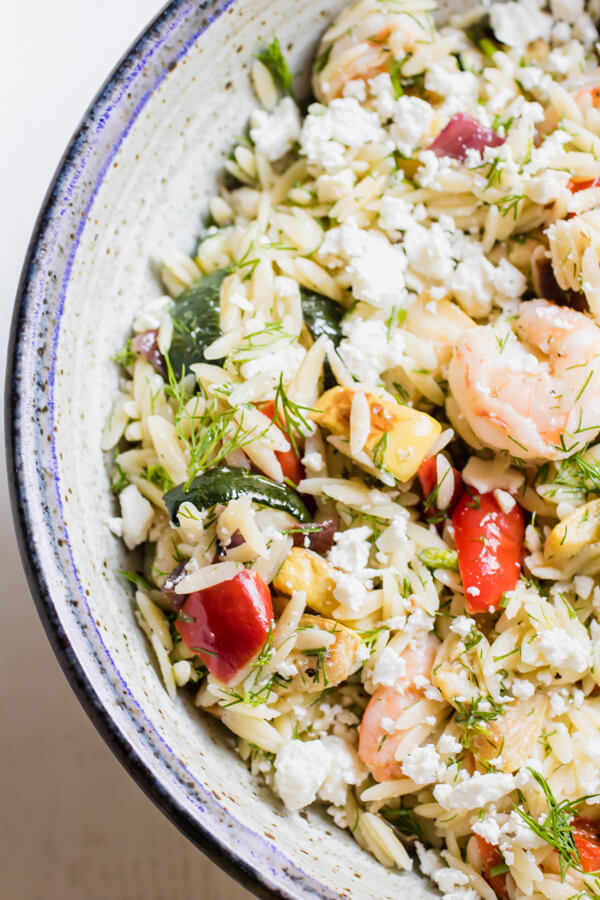 Loaded with fresh roasted vegetables, shrimp, dill, and feta cheese this Mediterranean inspired lemony orzo salad is a quick and easy summer side dish and is fantastic served warm or cold.Â 