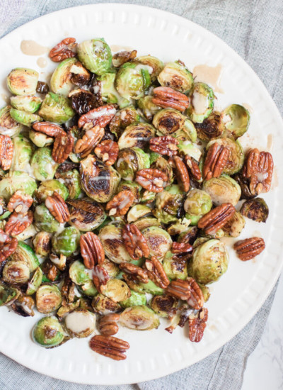 Gorgeous roasted Brussels sprouts tossed with crunchy pecans in a brown butter sauce and drizzled with a spiced maple tahini glaze.