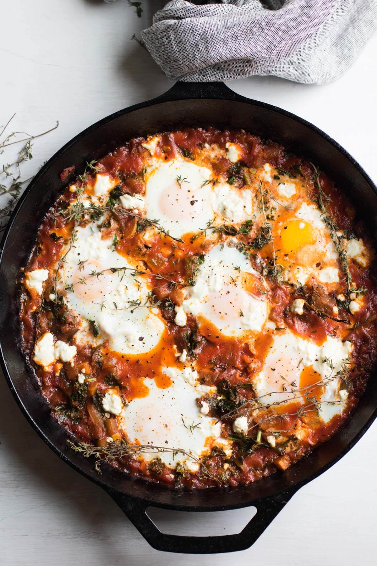 Ratatouille Shakshuka with Kale and Feta Cheese, eggs poached in a spicy tomato ratatouille sauce and topped with feta cheese. The PERFECT brunch dish. Gluten-free.