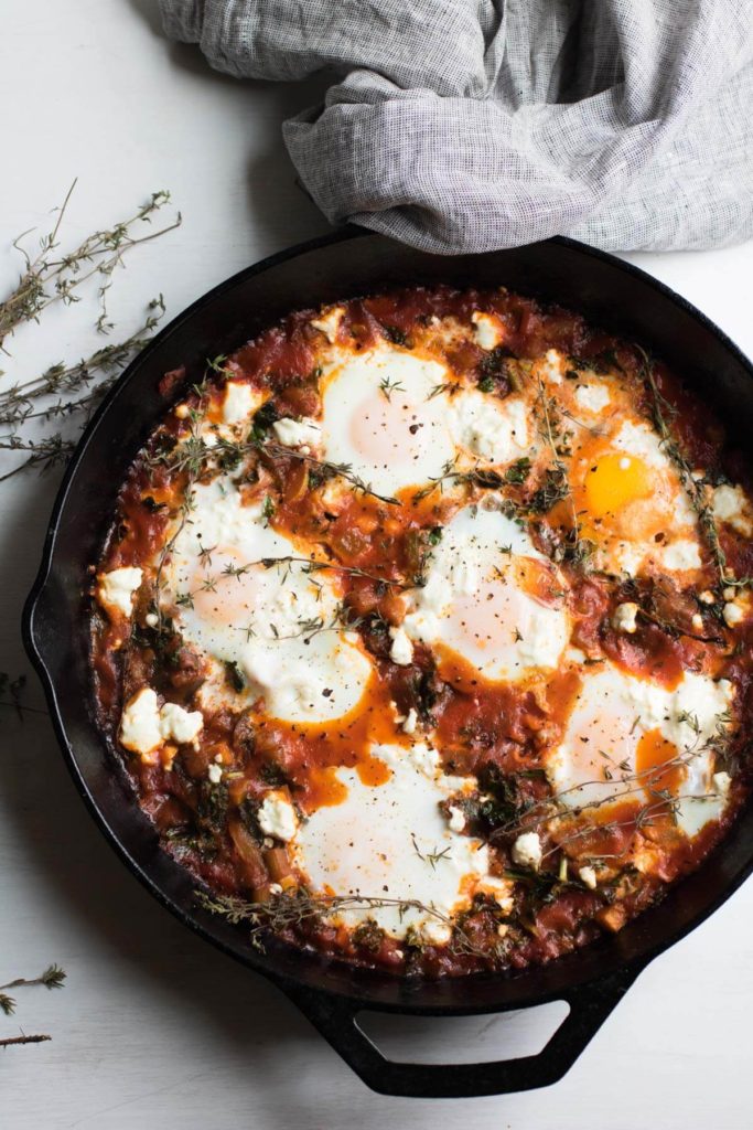 Ratatouille Shakshuka with Kale and Feta Cheese, eggs poached in a spicy tomato ratatouille sauce and topped with feta cheese. The PERFECT brunch dish. Gluten-free.