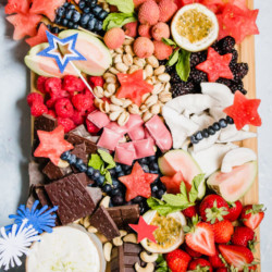 A festive healthy dessert board loaded with seasonal fruits, nuts, chocolate, and a heavenly whipped lime honey ricotta dip. The perfect party platter to wow your friends and family. 