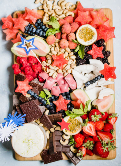 A festive healthy dessert board loaded with seasonal fruits, nuts, chocolate, and a heavenly whipped lime honey ricotta dip. The perfect party platter to wow your friends and family. 
