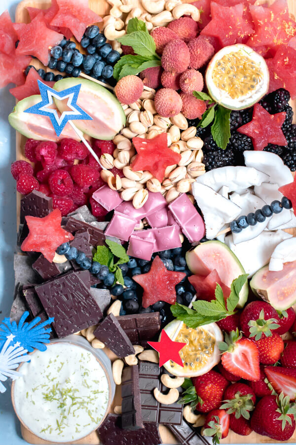 A festive healthy dessert board loaded with seasonal fruits, nuts, chocolate, and a heavenly whipped lime honey ricotta dip. The perfect party platter to wow your friends and family.Â 