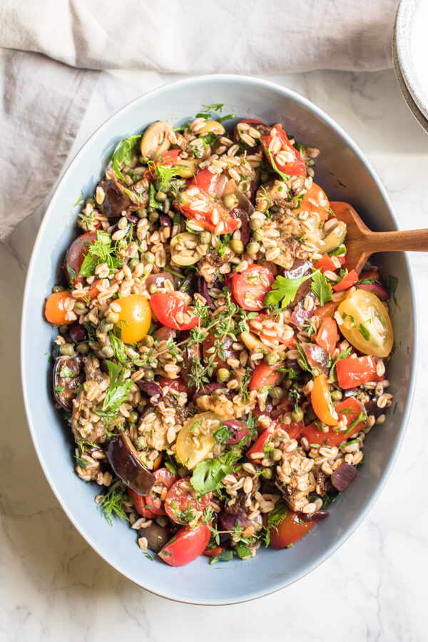 Nutty chewy (and super healthy) farro meet a bounty of fresh herbs, perfectly roasted eggplant, garden fresh tomatoes, and lots of kalamata olives! All tossed together in a garlic vinaigrette. This healthy vegan grain salad is easy enough to prepare and so delicious!
