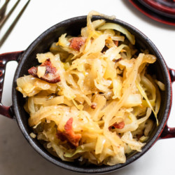 Easy Sauteed Cabbage, Sauerkraut, and Bacon in a small crock