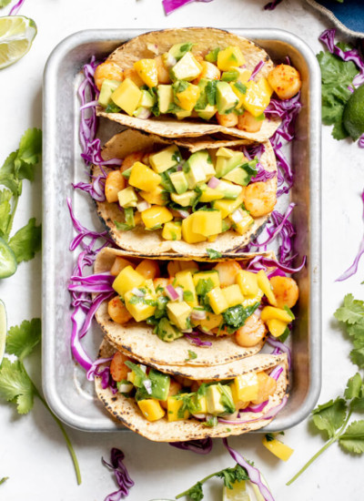 Seared Scallop Tacos with Mango Avocado Salsa on a sheet tray on a white background