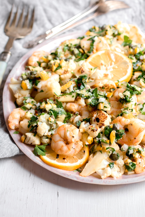 Perfectly roasted shrimp and cauliflower tossed with a bright and tangy Meyer lemon salsa. Dinner is done in 13 minutes! Paleo, gluten-free, quick, healthy, and easy.