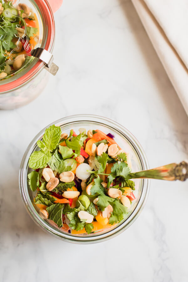 Healthy Thai Chickpea Jar Salad is the perfect meal prep lunch, this recipe makes 4 days worth of plant based delicious protein! Creamy spicy peanut butter dressing with chickpeas, crunchy vegetables, cilantro and salted peanuts. 