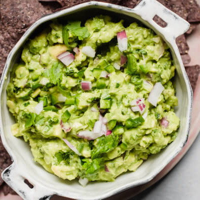 close up of white bowl of guacamole