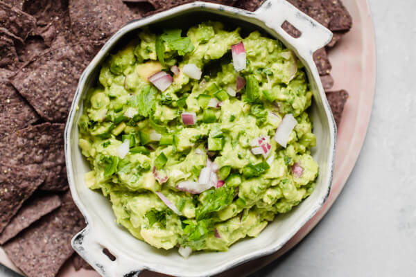 close up of white bowl of guacamole