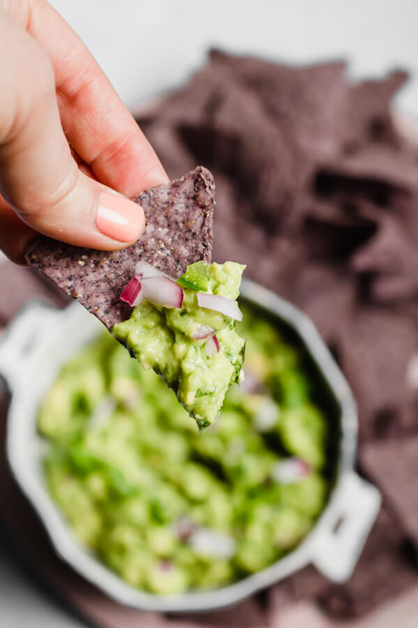 dipping chips into healthy guacamole