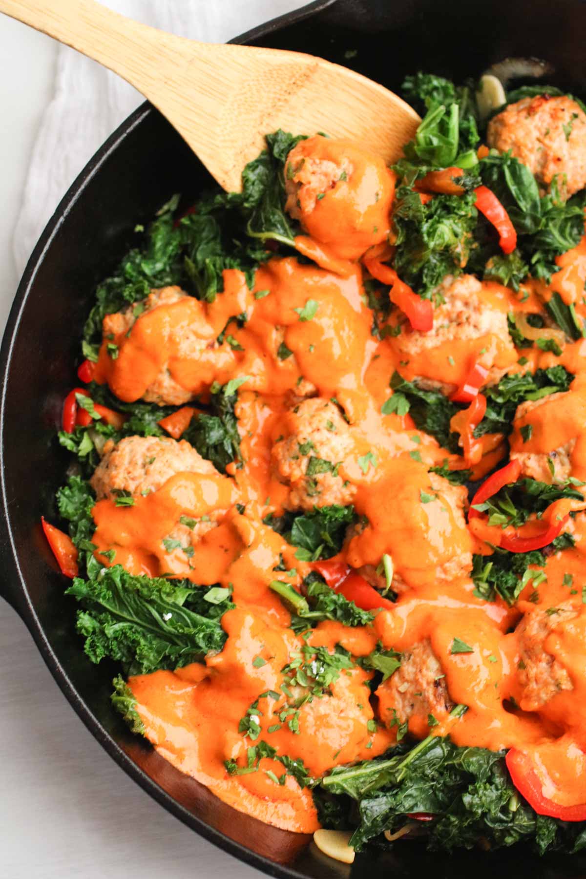 The best chicken meatballs in a creamy roasted red pepper sauce with sauteed kale. Oh my! 