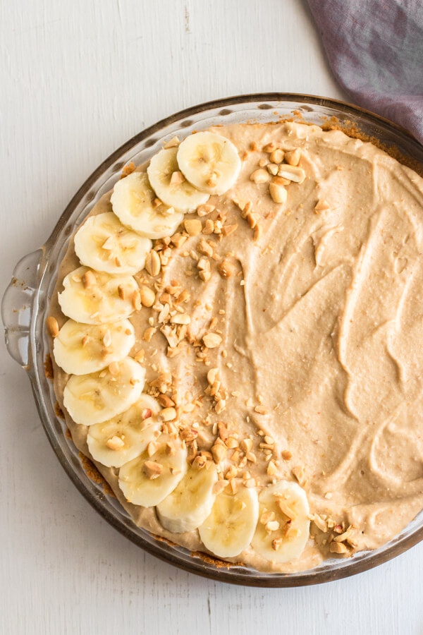 Creamy whipped peanut butter mousse piled high on top of sliced bananas and decadent chocolate avocado mousse, all nestled inside a graham cracker crust. The best peanut butter pie ever!
