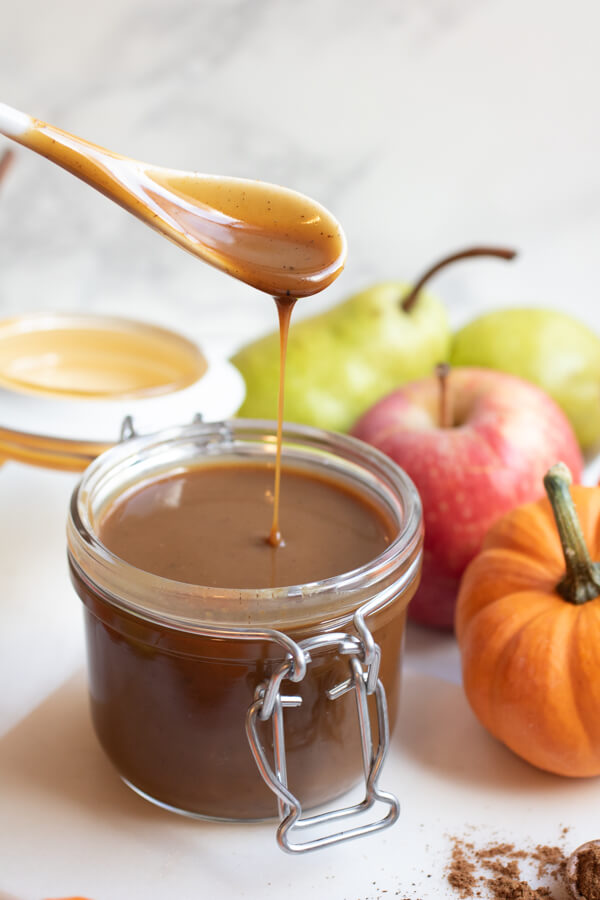 This silky, creamy, vegan pumpkin caramel sauce recipe is the perfect centerpiece for a DIY healthy caramel apple station. Learn how to make this easy fall caramel and get creative with your own caramel apple station!