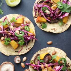 Vegan pumpkin shitake tacos combine creamy pumpkin and earthy shitake mushrooms with a crunchy-creamy lime slaw and perfectly spiced pumpkin seeds. This healthy recipe is done in 40 minutes flat! |abraskitchen.com