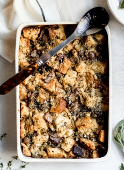 Sourdough Stuffing with Wild Mushrooms in white platter with spoon